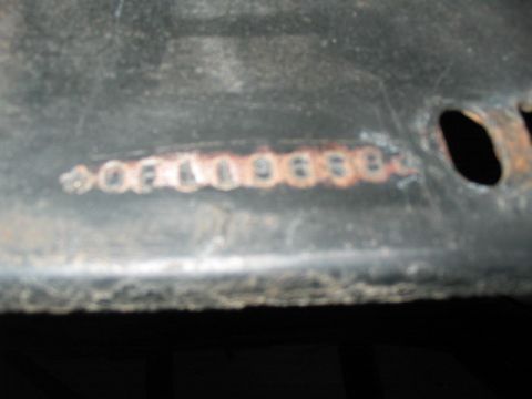 1970 Ford Mustang - Stamped numbers are visible on a dark metal part.