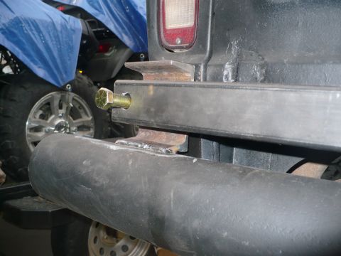 1979 Ford Bronco - Close-up of custom rear bumper hardware on a vehicle, with an ATV in the background.