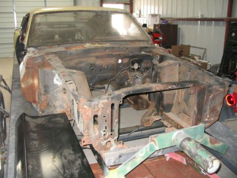 1970 Ford Mustang - Front view of a heavily rusted 1970 Ford Mustang chassis undergoing restoration.