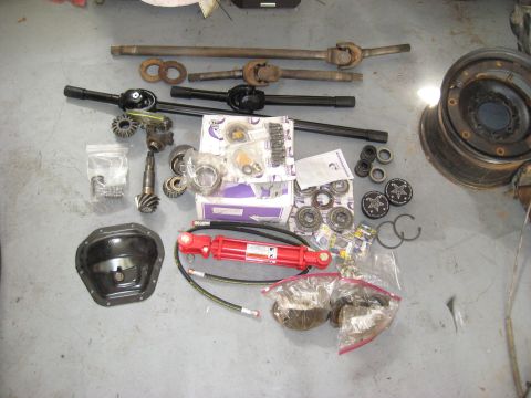 2008 Ford F-250 - Various vehicle drivetrain and suspension components laid out on a concrete floor.