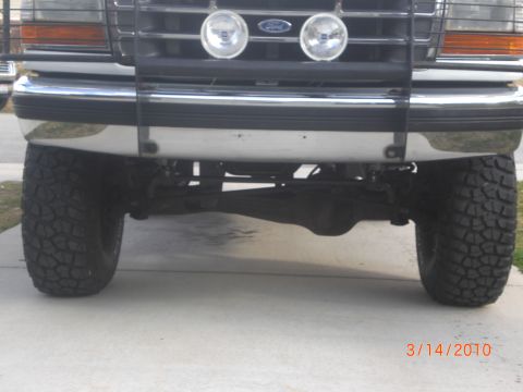 1995 Ford Bronco - This lifted 1992 Ford Bronco shows its front end, including large tires and a chrome bumper.
