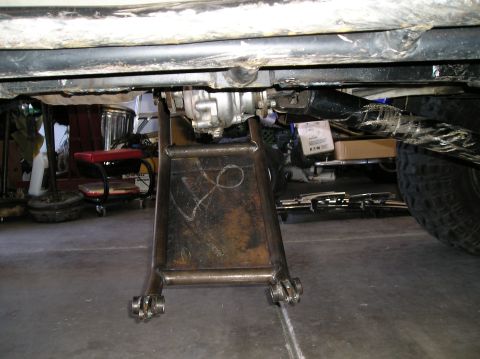 1986 Toyota Hilux - Underneath view of a vehicle's drivetrain components being worked on.