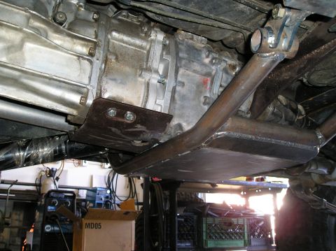 1986 Toyota Hilux - Custom skid plate installed on vehicle transmission and transfer case assembly.