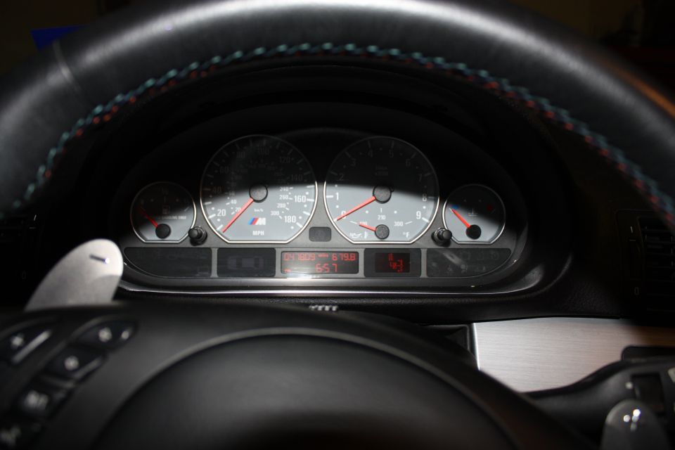 2004 BMW M3 dashboard with odometer showing 67958 miles and temperature gauge