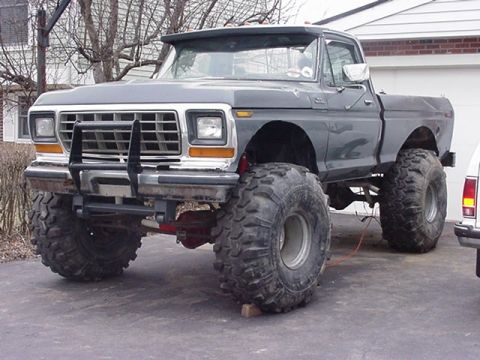 2002 Ford F-350 - This heavily modified pickup truck features oversized tires and a custom front bumper.