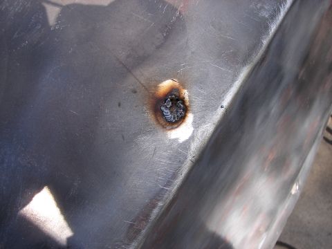 1973 Ford Ranchero - Metal panel repair showing a freshly welded spot with surrounding discoloration.