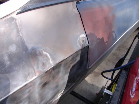 1973 Ford Ranchero - A car door and fender are shown with bodywork in progress, indicating repairs and preparation for painting.