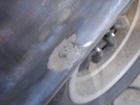 1973 Ford Ranchero - Body panel repair work is visible on this vehicle part, with a tire and wheel in the background.