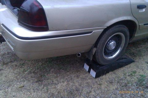 2000 Mercury Grand Marquis - Rear view of a 2000 Mercury Grand Marquis, with the rear wheel elevated on a ramp.