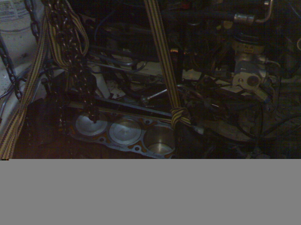 Engine block with pistons and cylinder head gasket removed