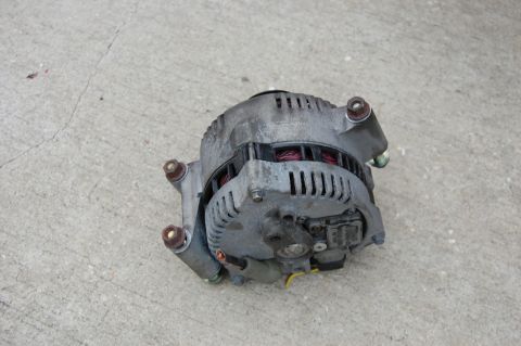 1994 Ford Bronco - This is a car alternator, likely removed from a vehicle for repair or replacement.