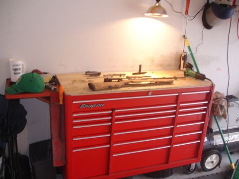 1989 Ford Bronco - Workbench with firearms and tools laid out on a Snap-on chest.