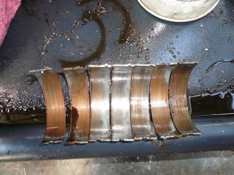 1975 Ford Ranchero - Engine bearings are shown with visible wear and oil residue, indicating potential mechanical issues.
