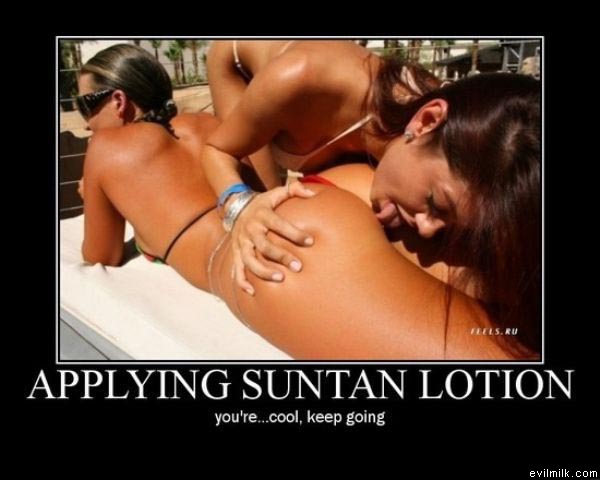Two women on a tanning bed, one applying lotion to the other