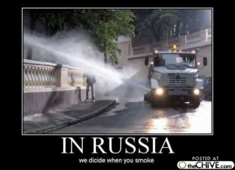 1989 Ford Bronco - A street cleaning truck sprays water onto a sidewalk and a person.