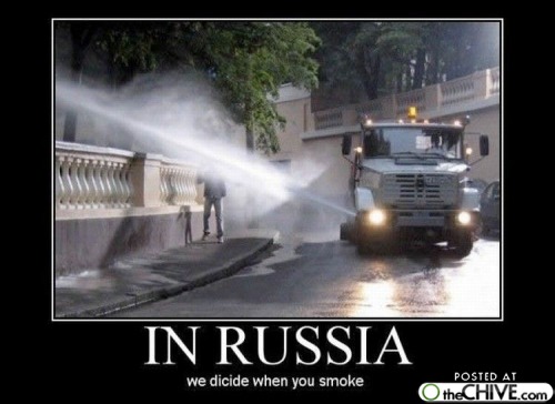 Front view of a street cleaning truck spraying water