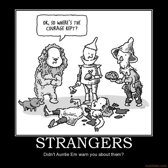 Cowardly Lion, Tin Man, and Scarecrow look at Dorothy on the ground. Poster text: STRANGERS. Didn't Auntie Em warn you about them?