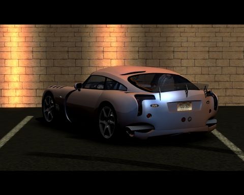 2000 Mercury Grand Marquis - A silver sports car is parked in front of a brick wall, showing its rear design and license plate.