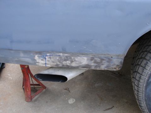 1973 Ford Ranchero - Side panel of a 1973 Ford Ranchero undergoing body repair, showing primer and filler work.