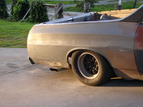 1973 Ford Ranchero - The rear of a Ford Ranchero shows its distinctive body style and aftermarket wheels, with a primer finish.