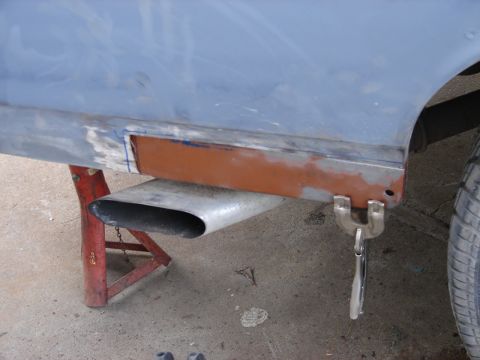 1973 Ford Ranchero - A 1973 Ford Ranchero undergoes bodywork, showing a section of the side panel being prepared for repair.