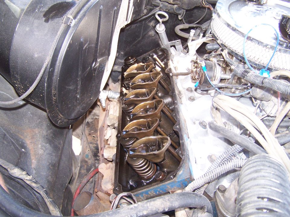 Close-up of engine valve train with rocker arms and springs visible
