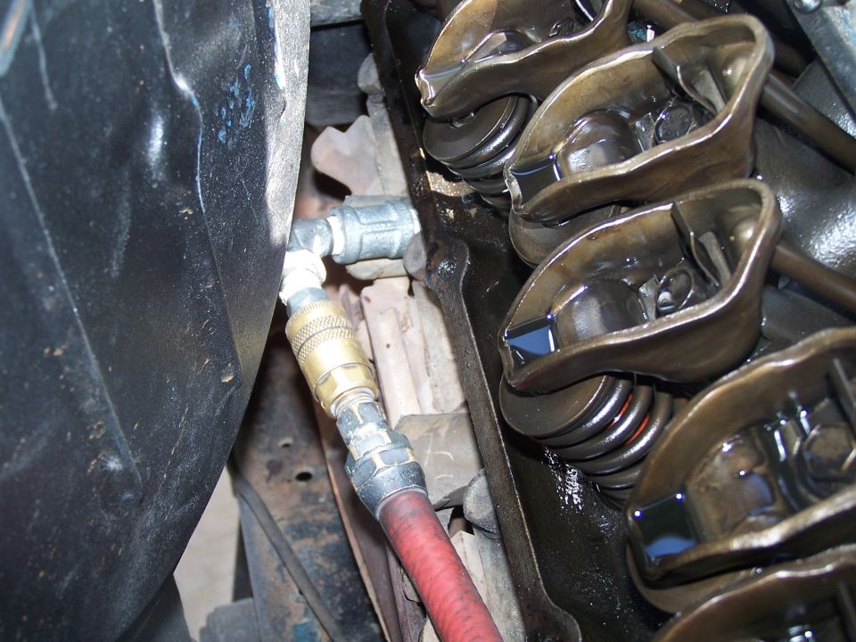 Engine valve train with air hose connected to cylinder head