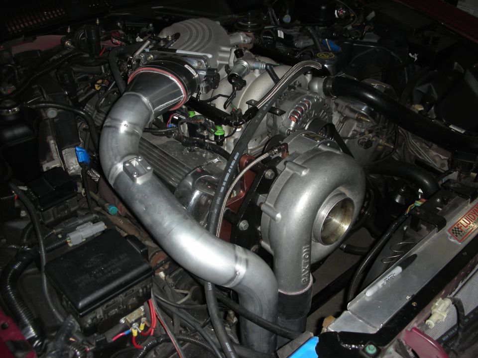 Engine bay with turbocharger, intercooler piping, and custom intake
