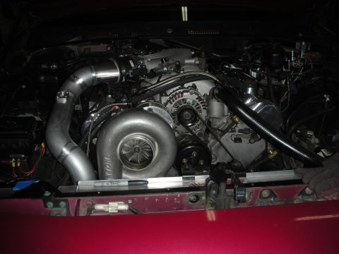 1992 Ford Crown Victoria - Custom turbocharger installation in an engine bay, showing intercooler piping and engine components.
