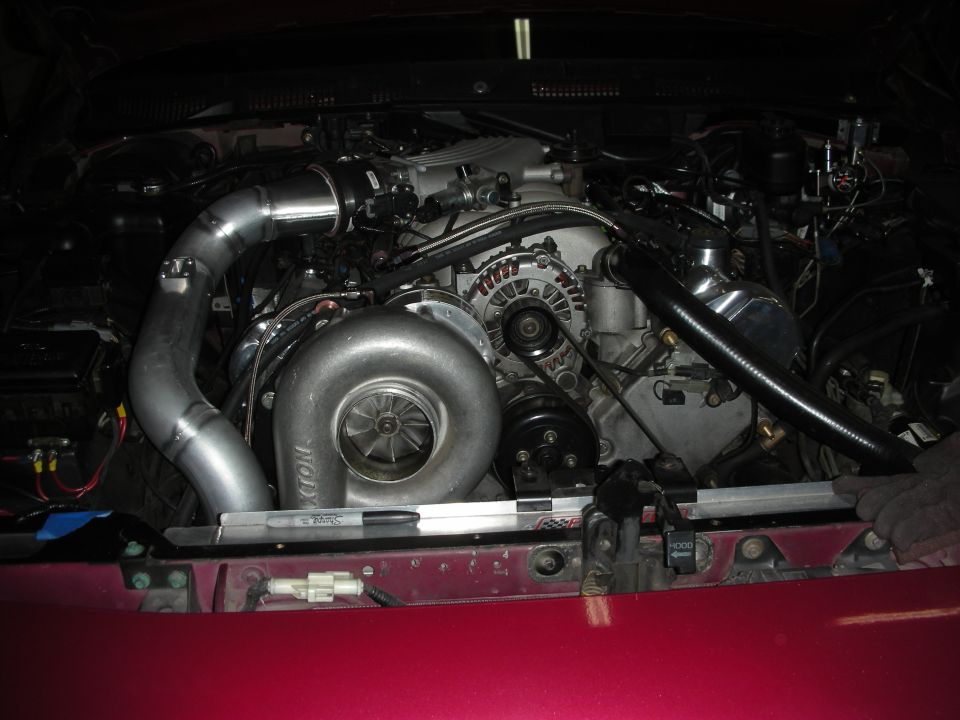 Engine bay with large turbocharger and custom piping installed