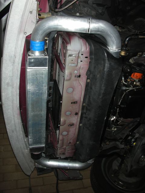 1992 Ford Crown Victoria - Custom intercooler and piping installation, likely for a performance upgrade, shown in the front of a vehicle.