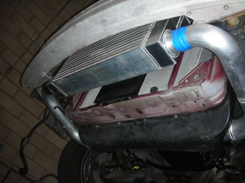 1992 Ford Crown Victoria - Custom intercooler and piping installation visible from underneath a vehicle.