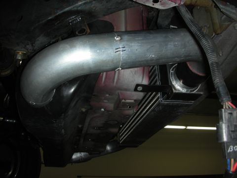1992 Ford Crown Victoria - Custom intercooler piping and radiator installed under a vehicle, showing modifications to the engine bay.