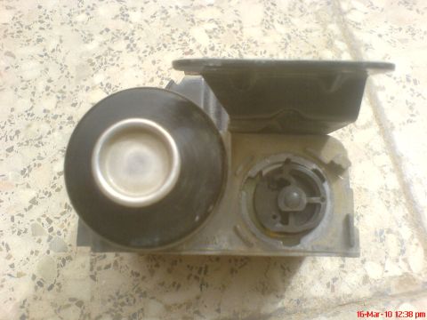 1998 Ford Crown Victoria - A cruise control actuator is shown, a black diaphragm and a central rotating component.