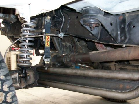 1996 Ford Bronco - Undercarriage view of a vehicle's suspension system, showing custom modifications.