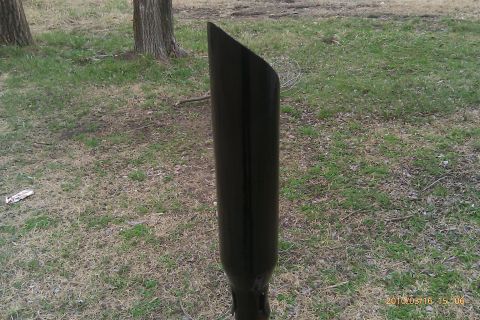 2000 Mercury Grand Marquis - A black exhaust pipe is shown outdoors in a grassy area with trees in the background.