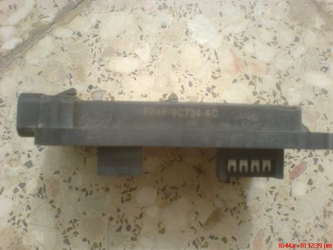 1998 Ford Crown Victoria - Ford cruise control module part F6AF-9C734-AC shown on a speckled surface.