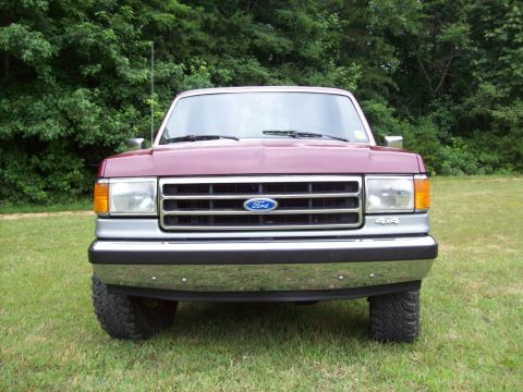 1990 Ford F-150 - Front view of a maroon 1990 Ford F-150 pickup truck, its iconic grille and chrome bumper.
