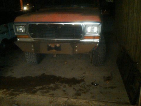 1987 Ford Bronco - Front view of an orange Ford Bronco, likely from the early 1980s, with a custom bumper.