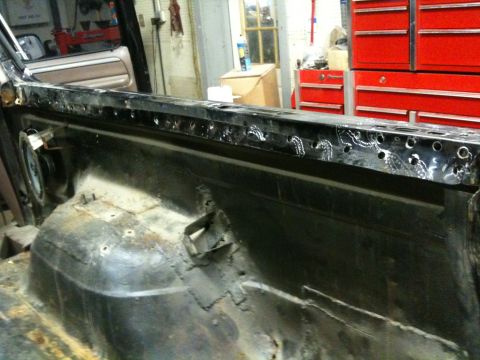 1993 Ford Bronco - Close-up of a heavily rusted vehicle body panel, likely undergoing repair.