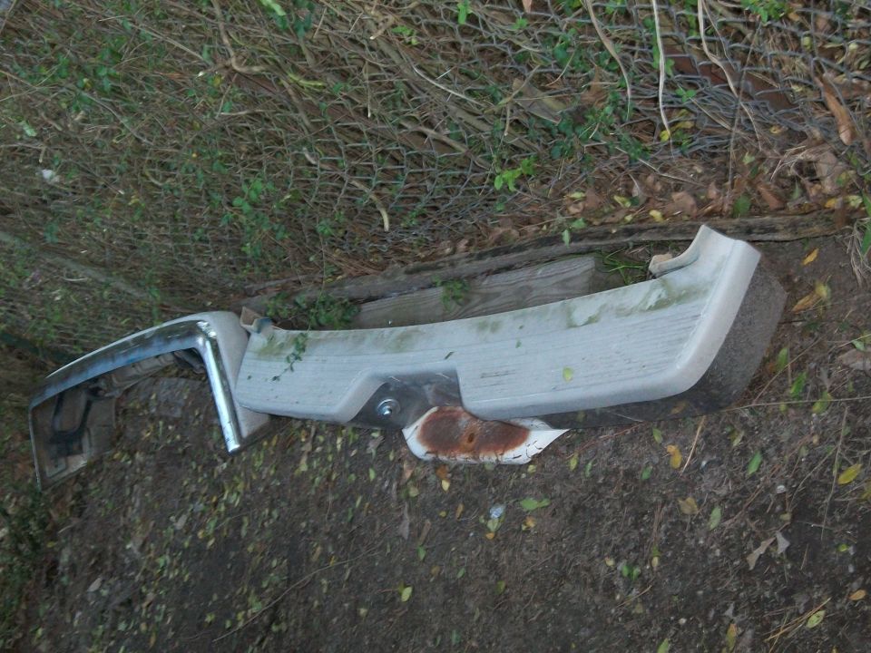 White automotive interior trim panel lying on the ground