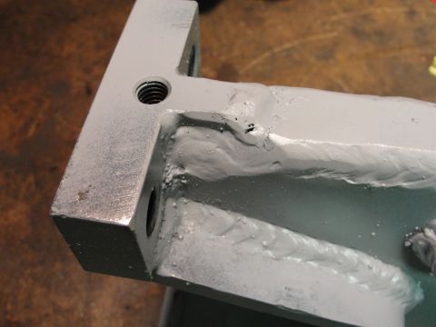 1995 Ford Bronco - A close-up view of a metal component, showing welds and threaded mounting points.