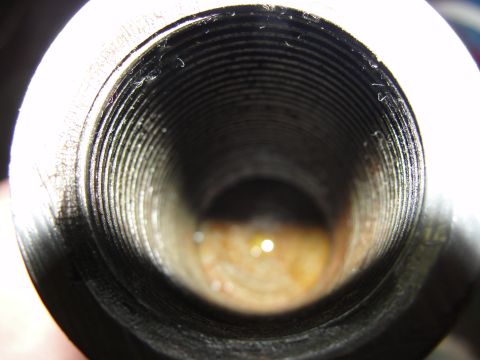 1995 Ford Bronco - The interior of a threaded metal component, possibly a pipe fitting or a part of a larger mechanism.