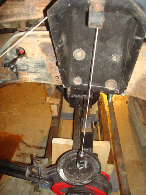 1995 Ford Bronco - Close-up view of a vehicle's solid axle assembly, showing suspension mounting points and brake drum.