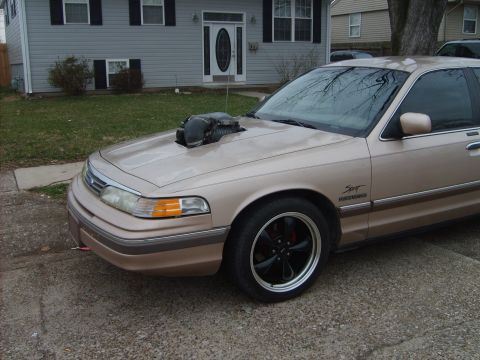 1993 Ford Crown Victoria - This 1993 Ford Crown Victoria features a prominent hood scoop and custom wheels.