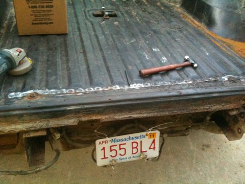 1993 Ford Bronco - Tools are laid out in a rusty truck bed, ready for repair work.