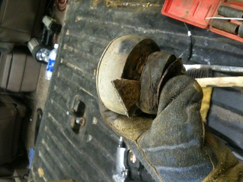 1993 Ford Bronco - Close-up of a damaged exhaust pipe section being held, with tools in the background.
