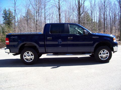 1978 Ford F-150 - This dark blue Ford F-150 pickup truck is shown from the side, a crew cab and chrome accents.