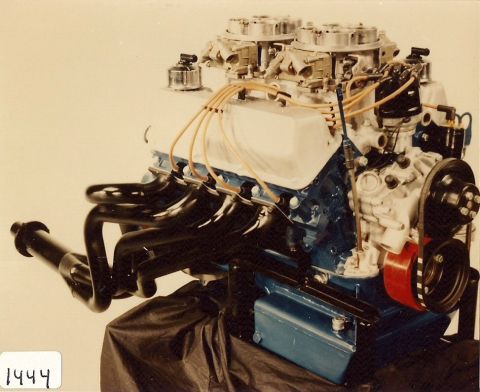 1973 Ford Mustang - Ford V8 engine dual carburetors and custom exhaust headers, displayed on a stand.