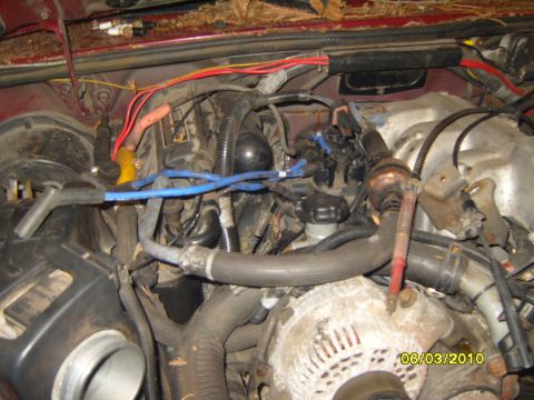1989 Ford Bronco - Close-up view of an engine bay, focusing on spark plug wires and alternator. Date stamp visible.